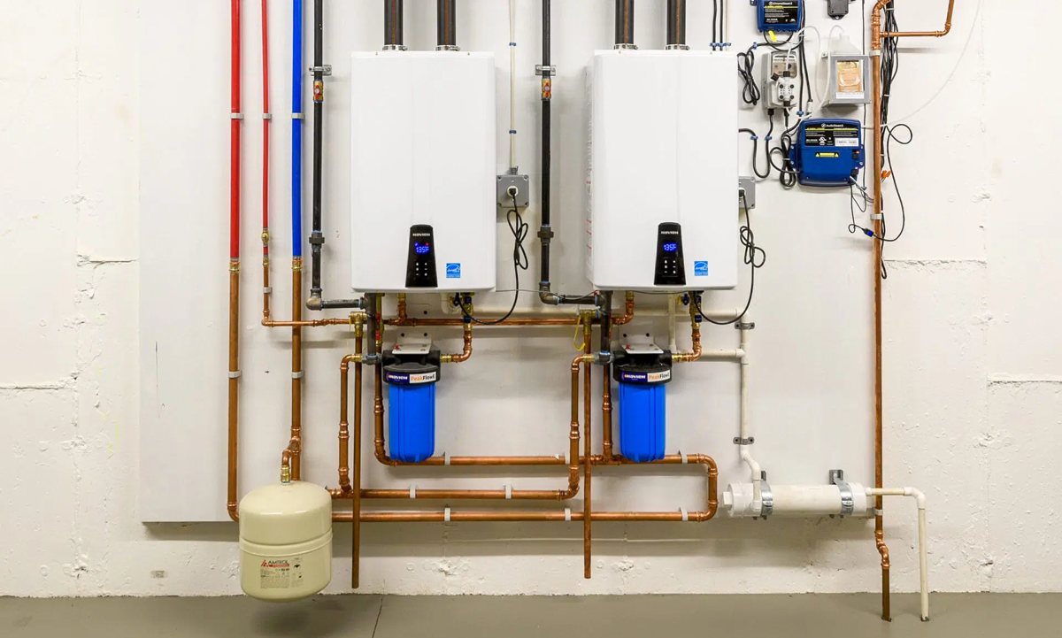 Two wall-mounted tankless water heaters with copper piping
